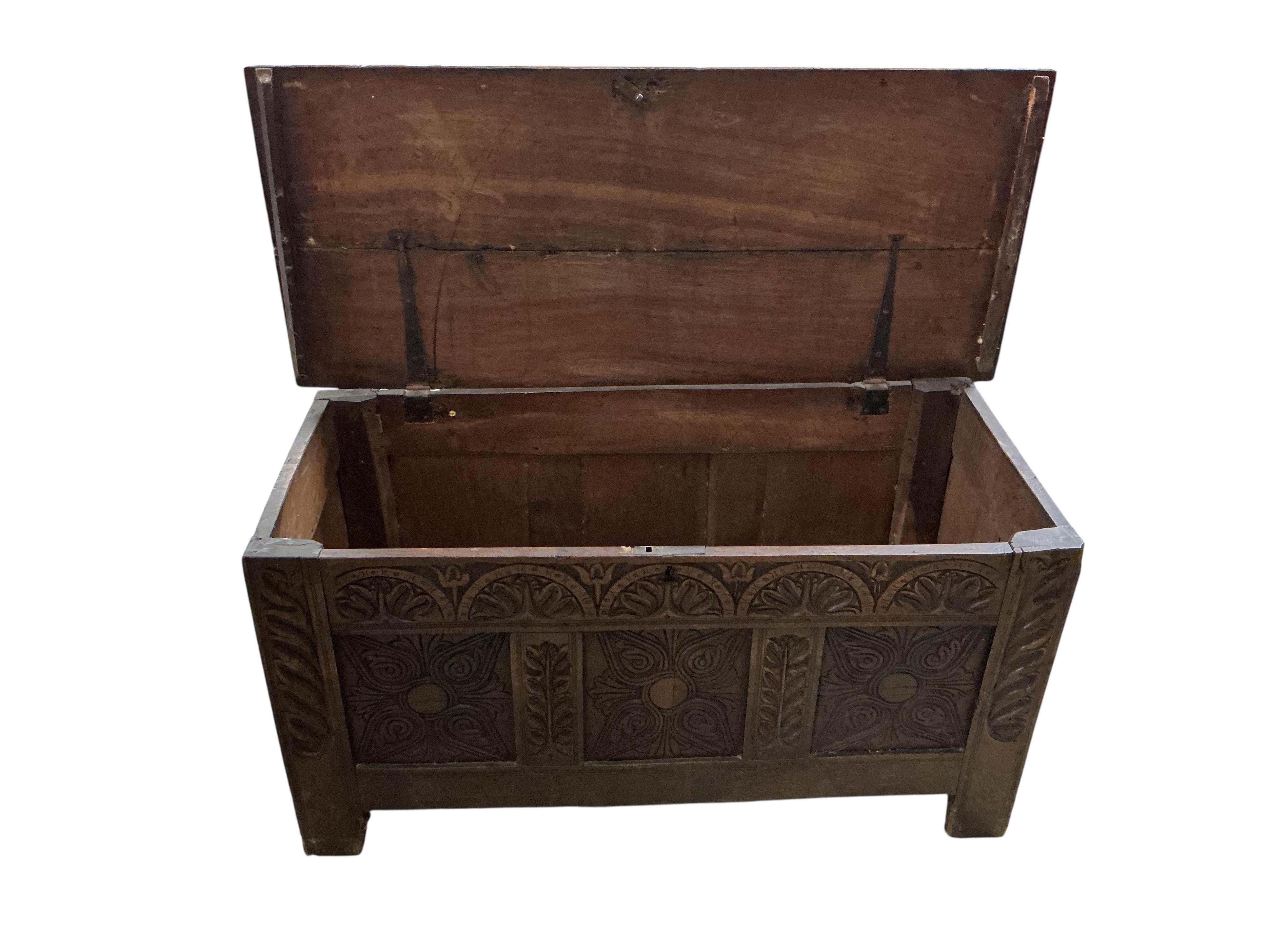 An 18th century carved oak coffer, width 132cm, depth 56cm, height 64cm